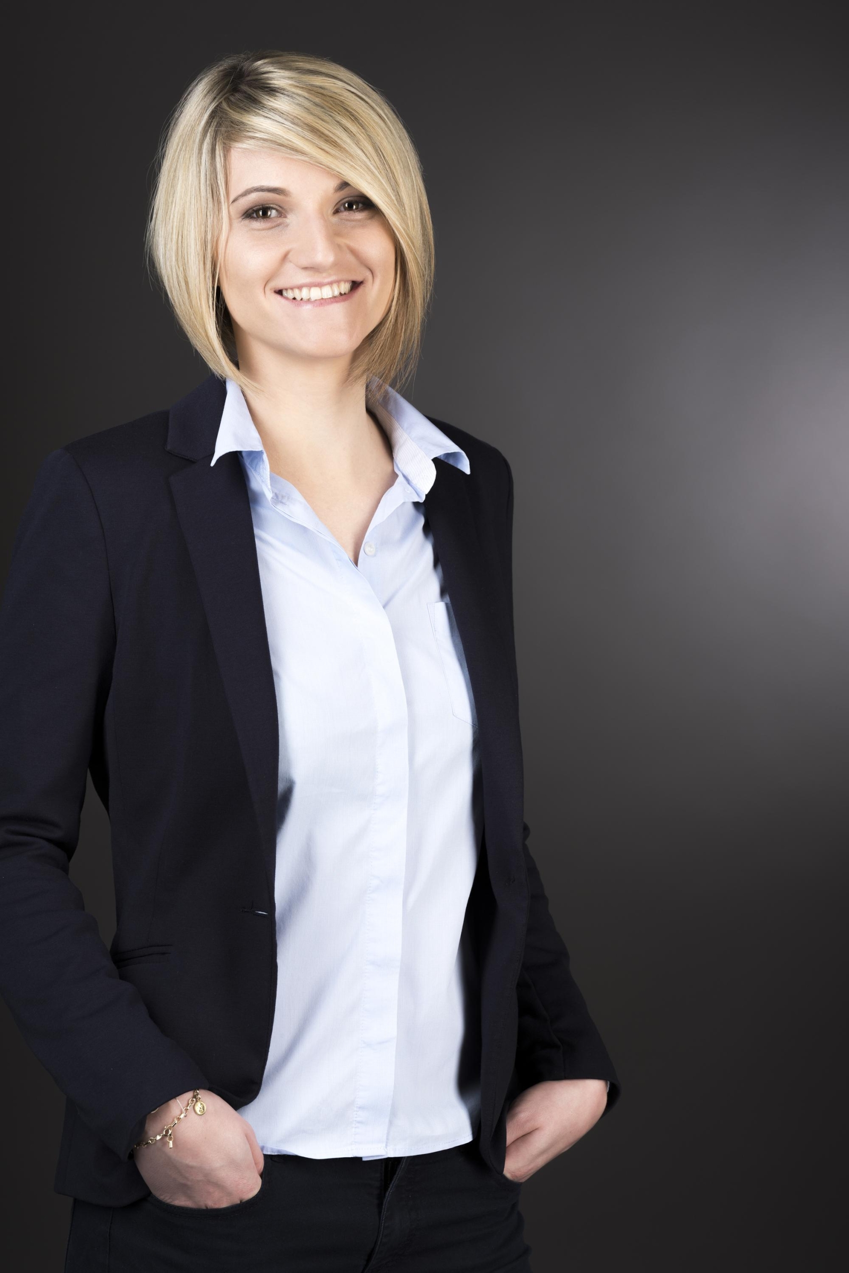 Christine Fasching, Head of Sales and Business Development at NEULANDT in a blazer and a blouse