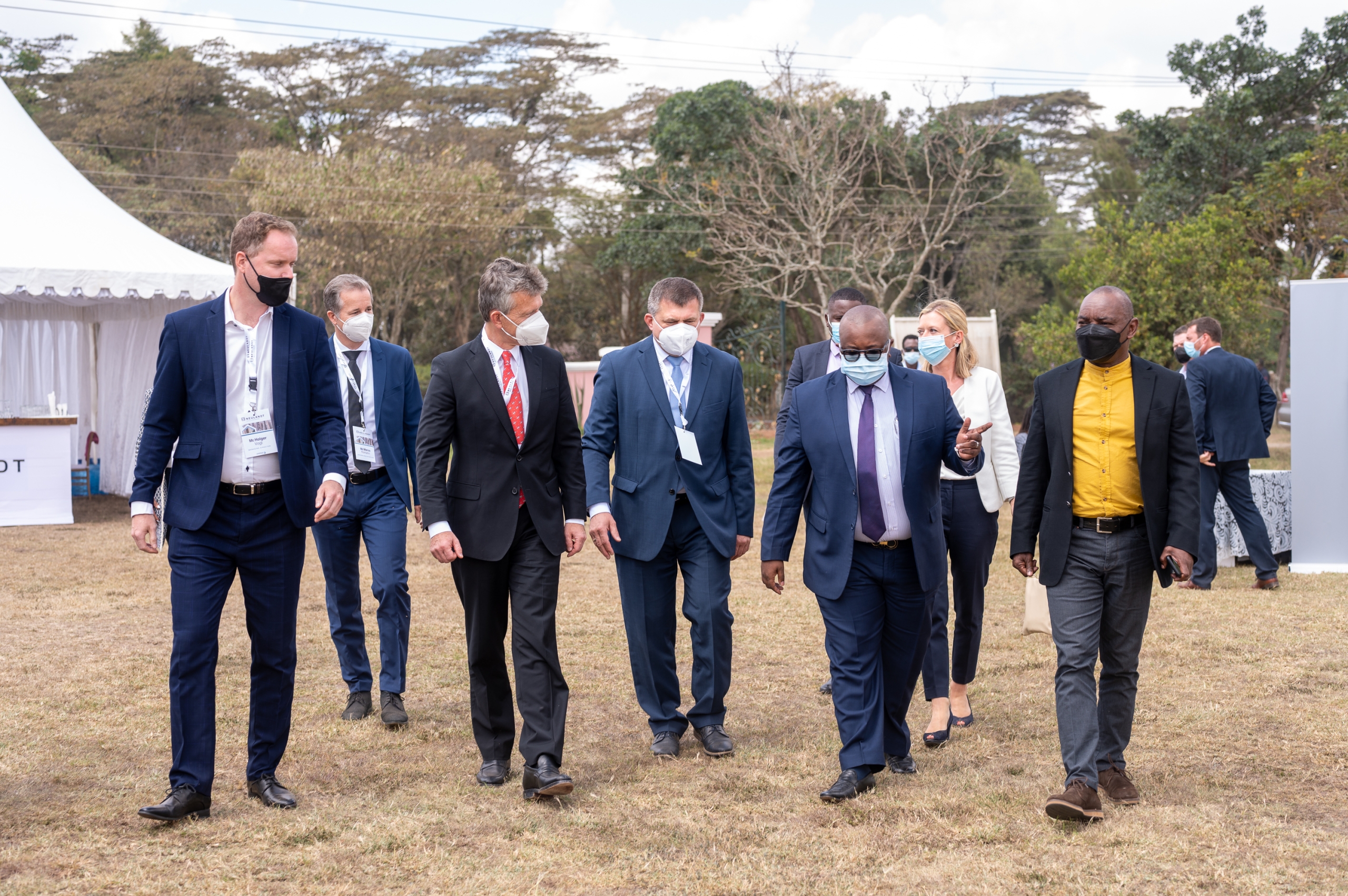 Crowd of business people including NEULANDT Managing Director Marco Romahn are walking on the NCA show ground in Kenia